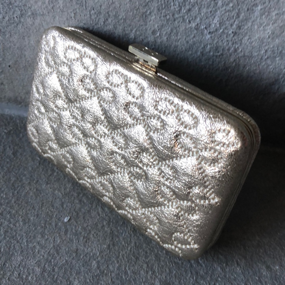 Designer Anya Hindmarch card holder in gold.